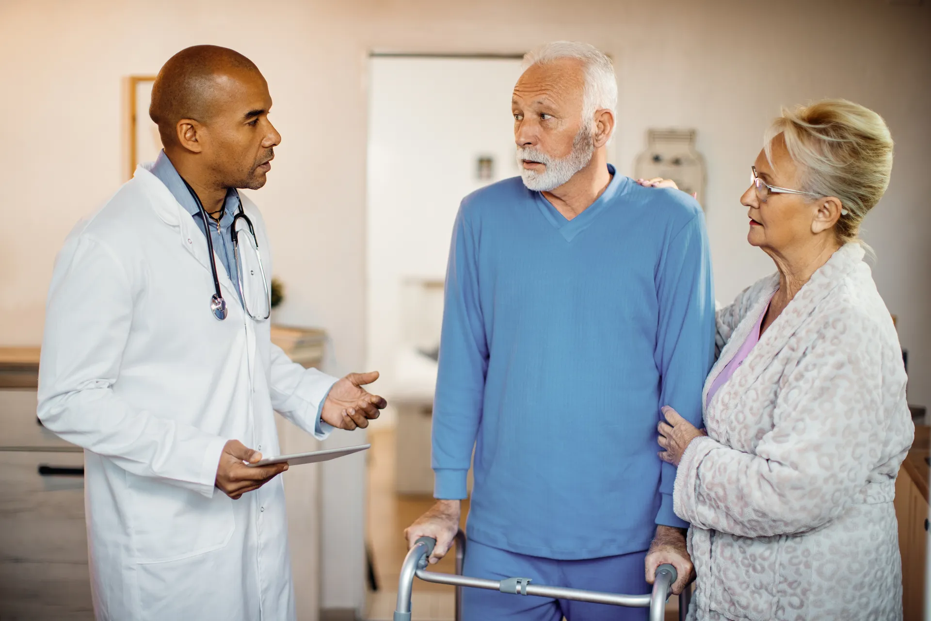 Care worker with an older couple at home